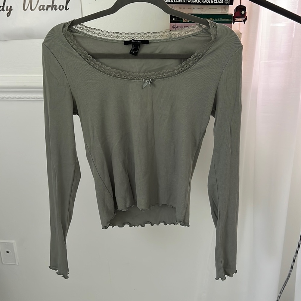 Sage green long sleeved top with lace and lettuce trim